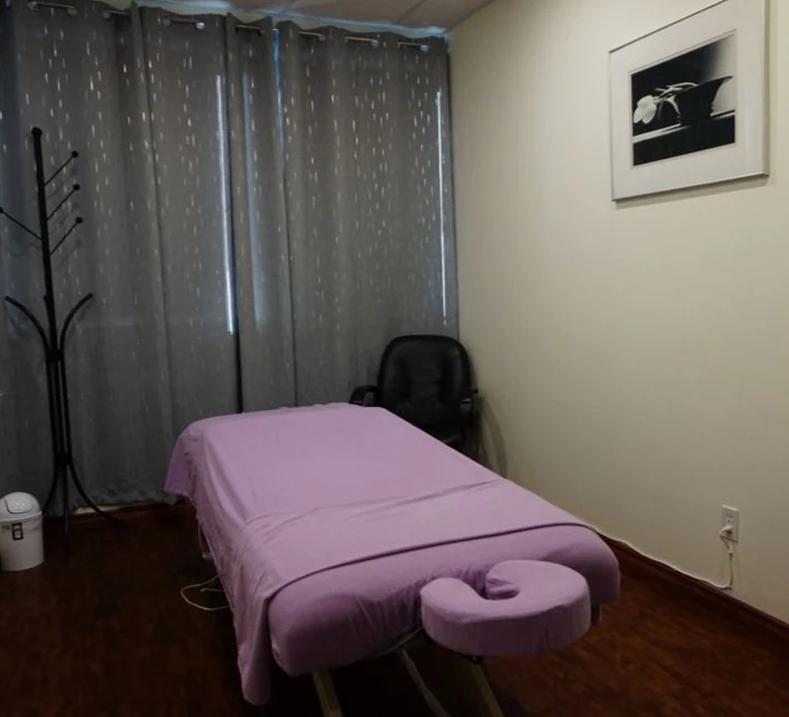 Private massage treatment room with therapy table